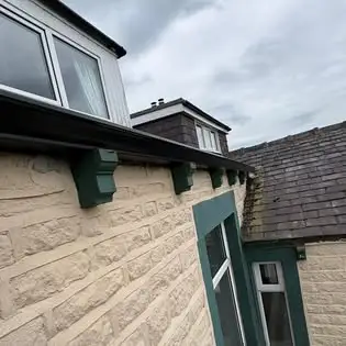 Stone house exterior with seamless gutters in Lancashire