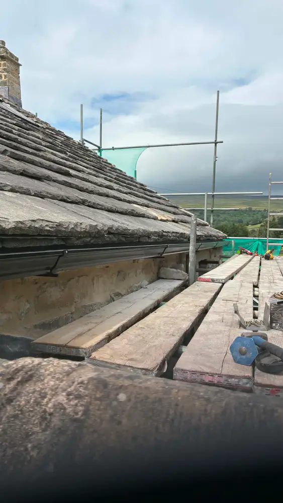 Seamless gutter and roofline installation completed from scaffolding