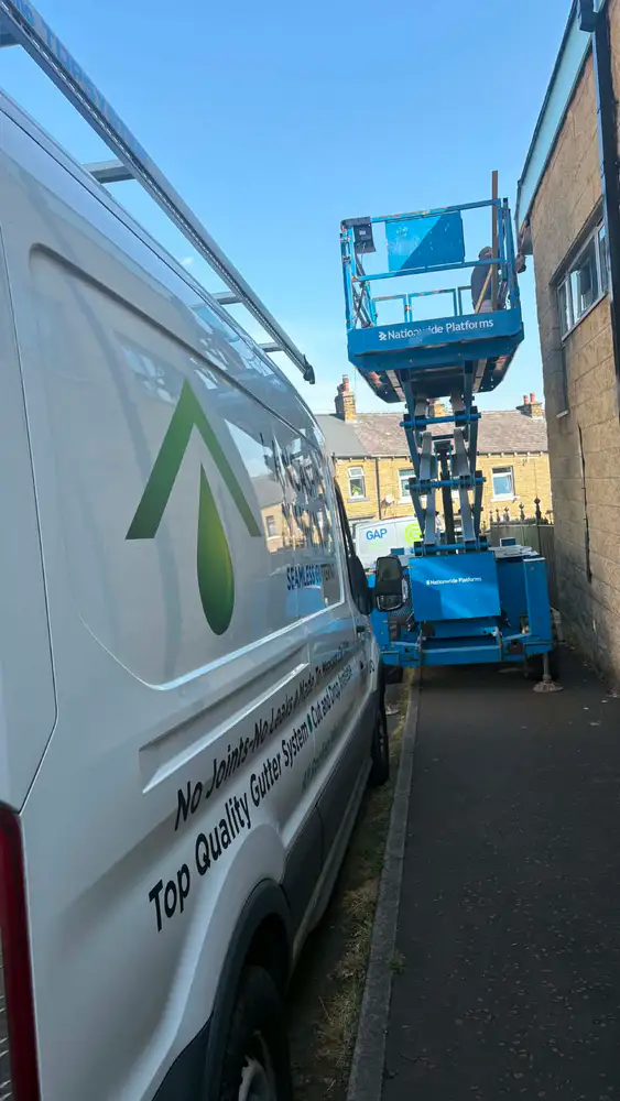 Seamless guttering van and scissor lift ready for a commercial installation