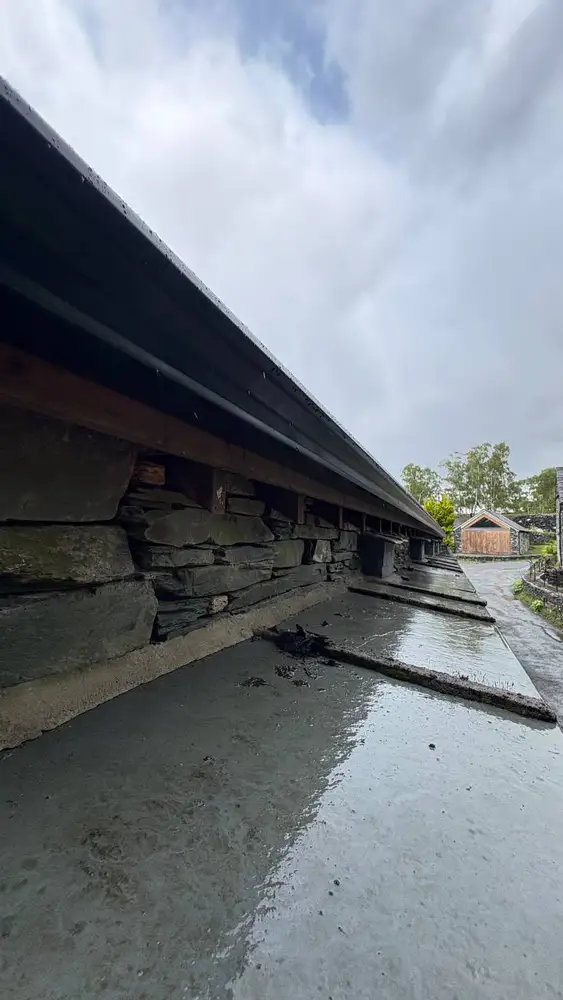 Close view beneath a newly fitted gutter on a slate building