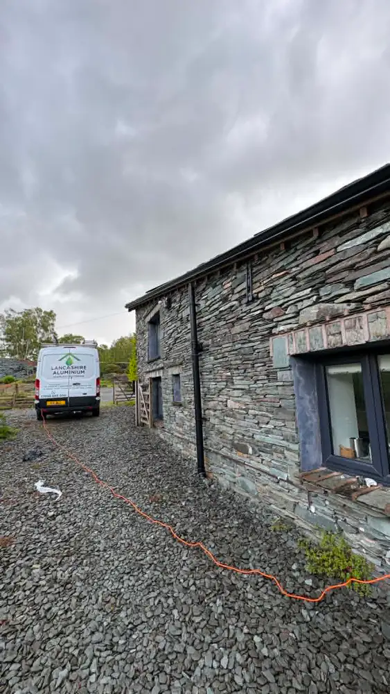 Seamless aluminium guttering installed on a traditional stone barn
