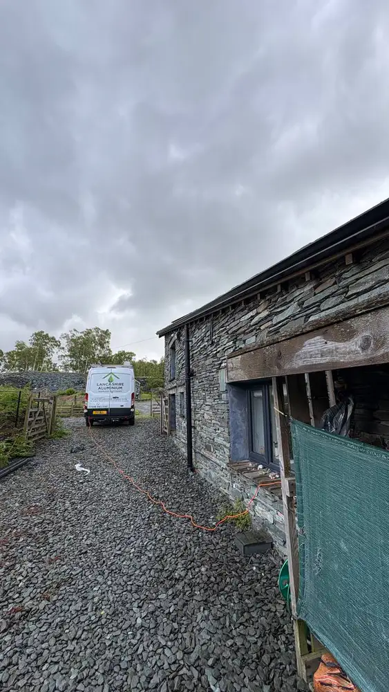 Stone barn protected by new seamless guttering and downpipes