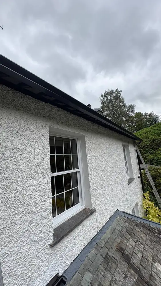 Black aluminium gutter system on a white house